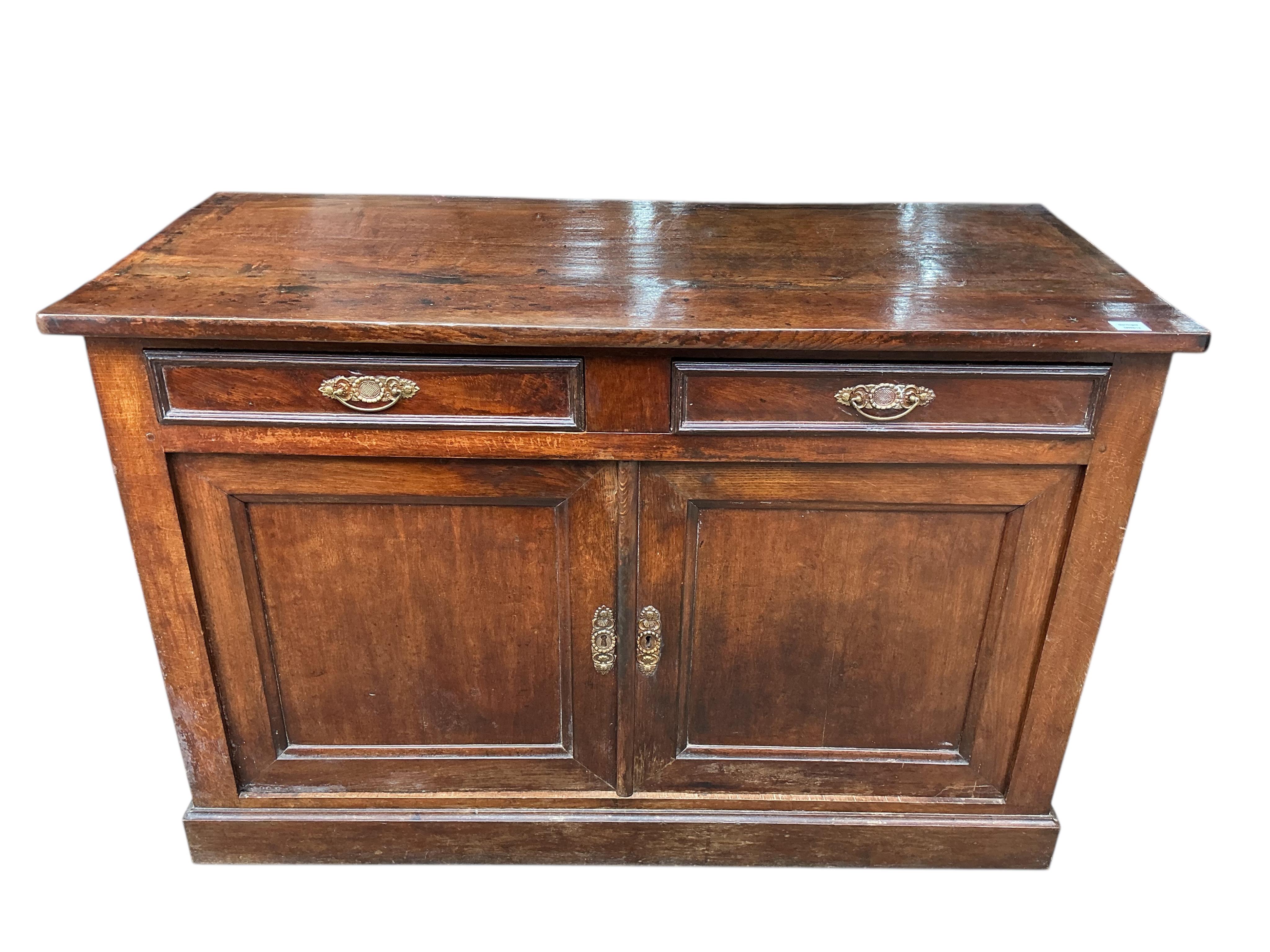 An early 19th century French oak and fruit wood buffet, width 140cm, depth 62cm, height 92cm